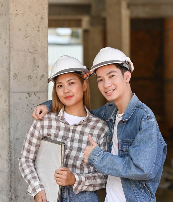 two-happy-investors-in-helmet-standing-at-construction-site-real-estate-investors-concept